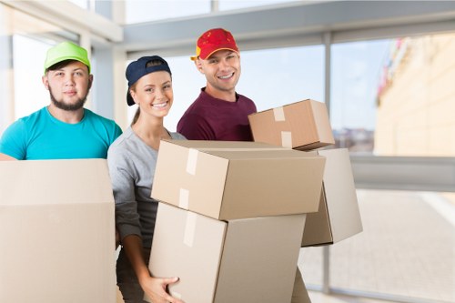 Removal team preparing flat removals in Bermondsey with moving boxes and furniture